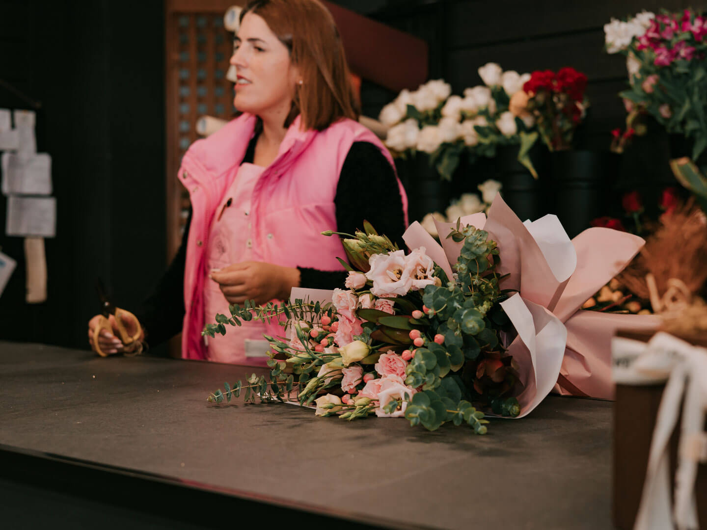 Black and white photo of a women performing modern dance on a dark background.